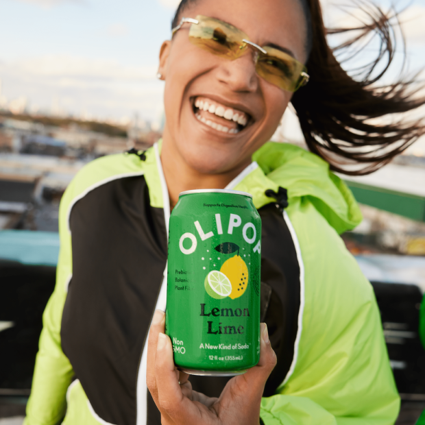 Woman Holding a Can of OLIPOP LEMON LIME